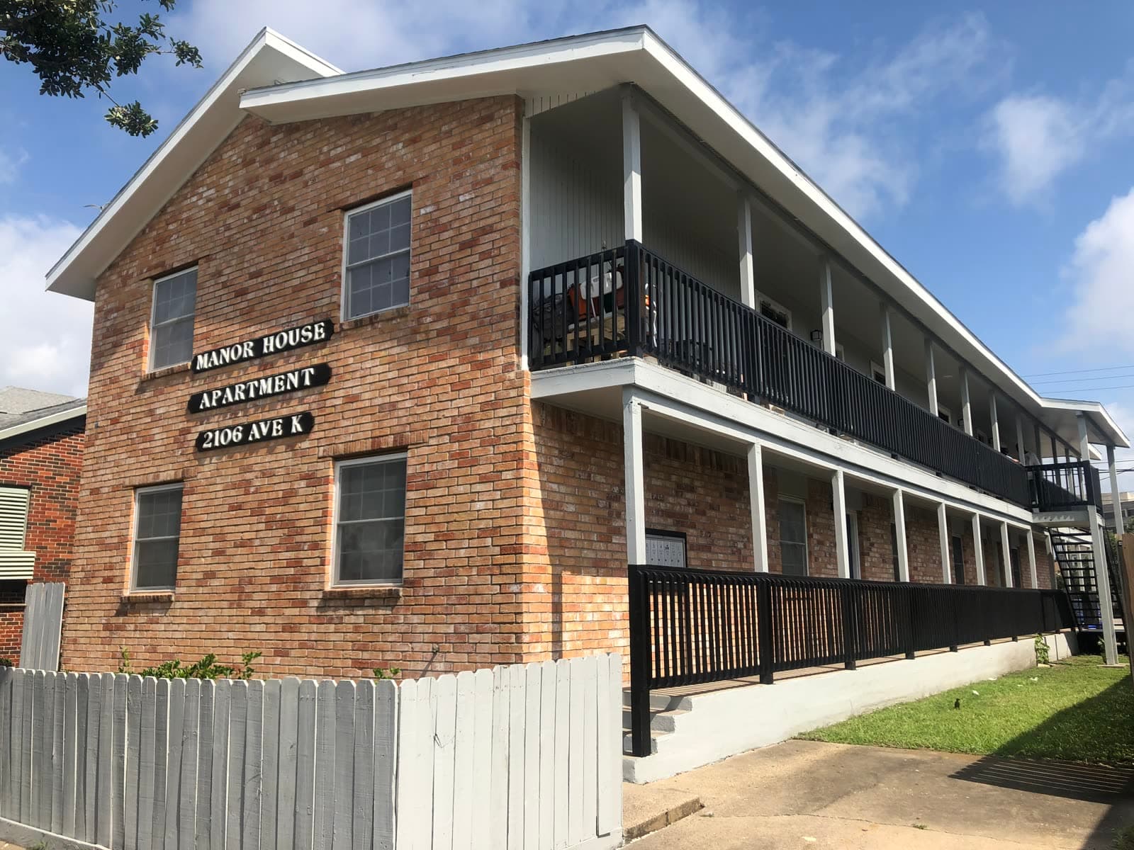 Brick exterior of 2106 Avenue K in Galveston, building-level view with no unit numbers
