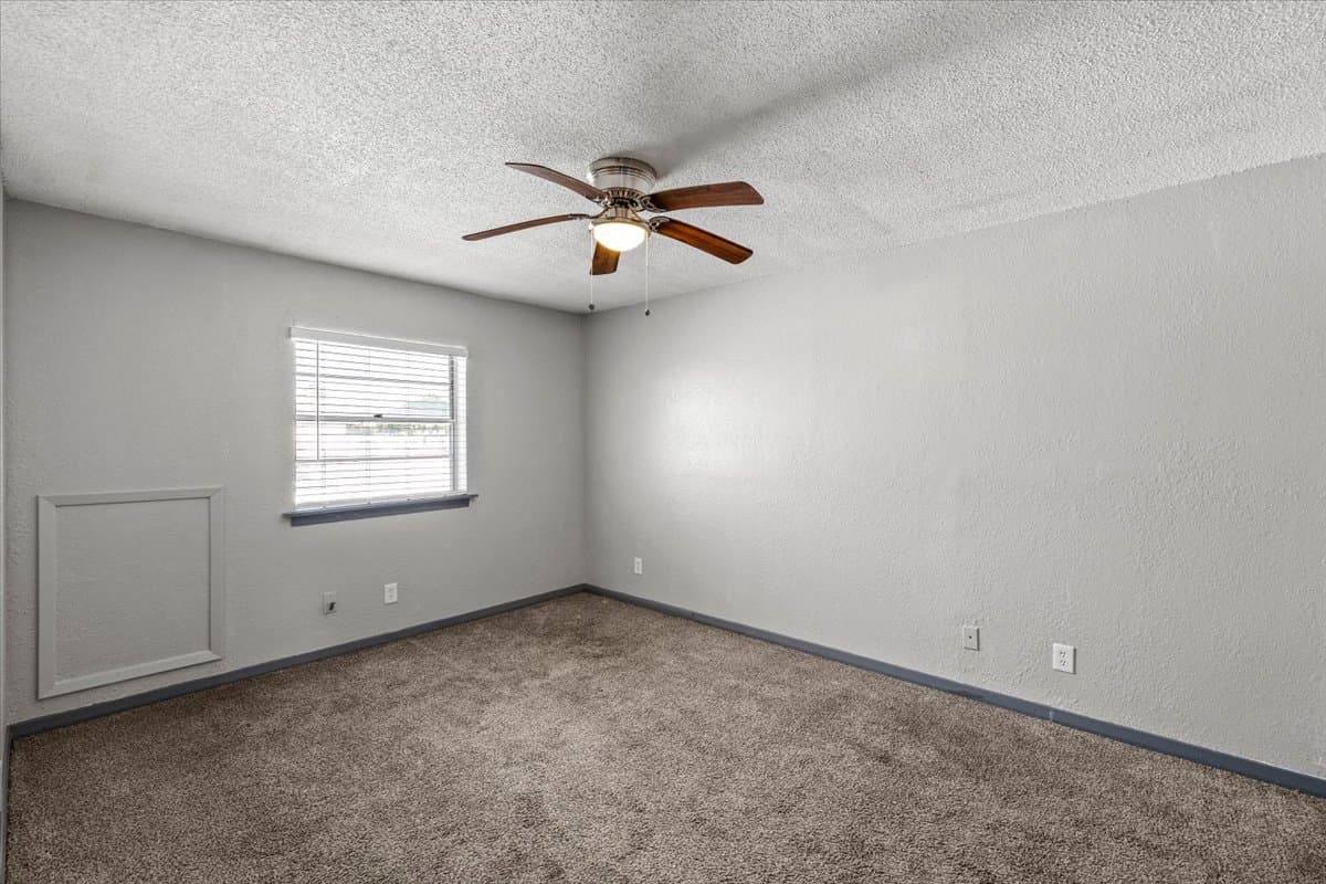 Renovated bedroom with carpet and ceiling fan at 320 Market Street