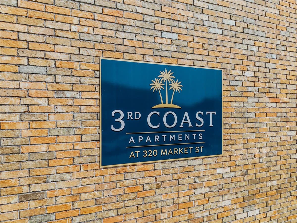 3rd Coast Apartments sign on the brick exterior at 320 Market Street near UTMB, Galveston