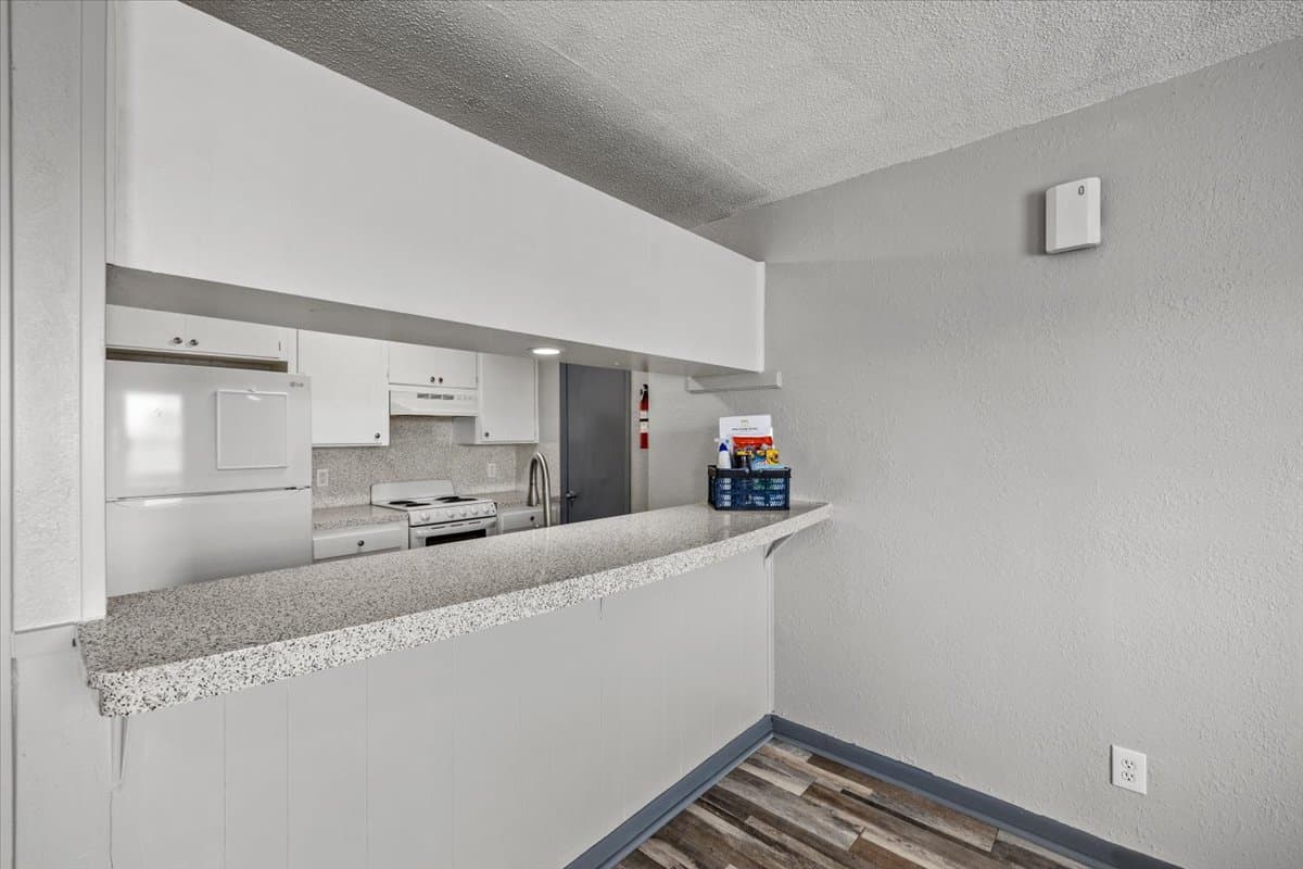 Renovated pass-through kitchen and vinyl plank living area at 320 Market Street